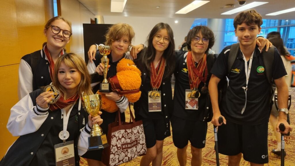 AISM students at the World Scholar's Cup Global Round 2026 after winning debate trophies, gold medals and silver medals.