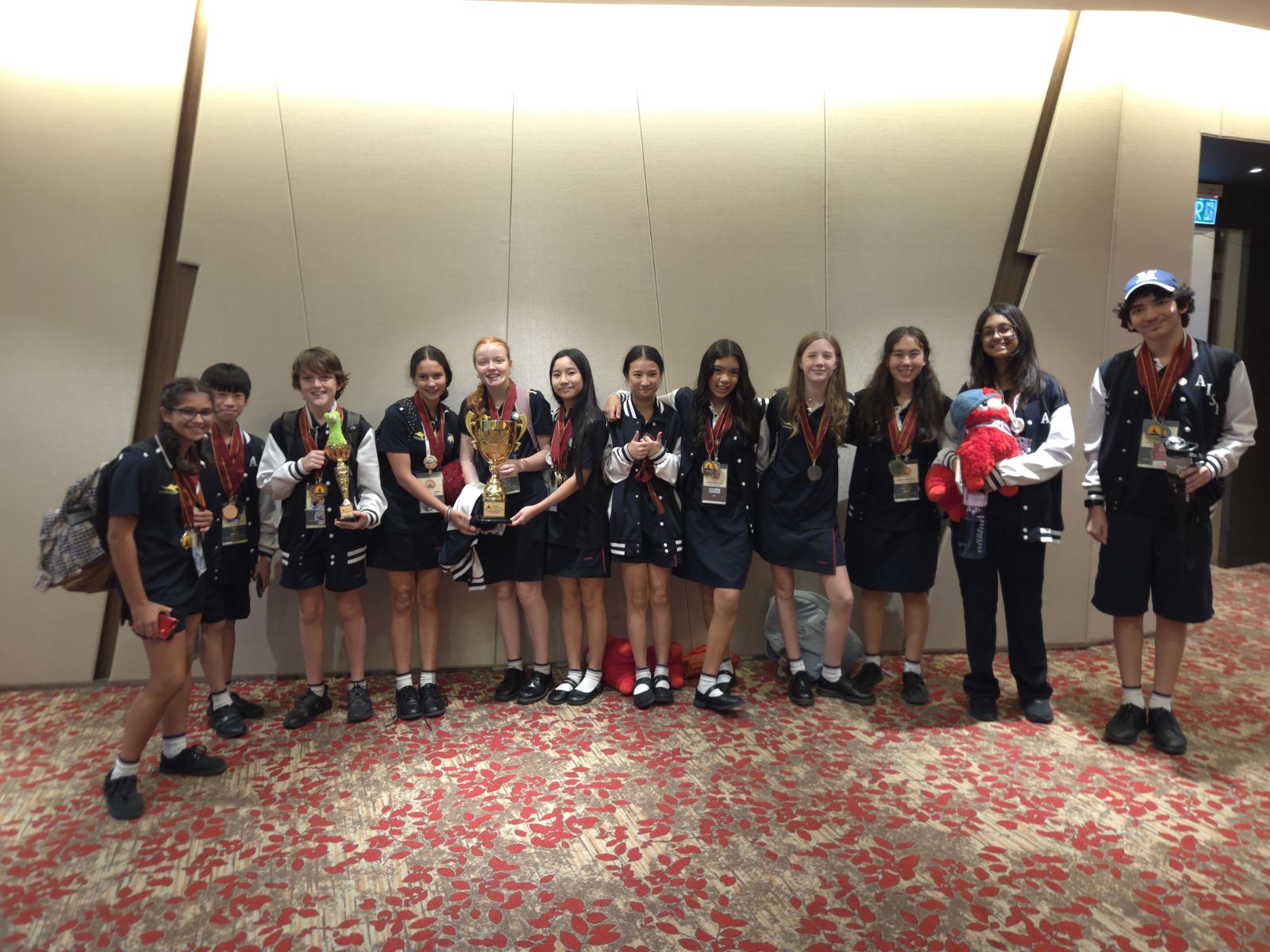 AISM students at the World Scholar's Cup Global Round 2026 after winning debate trophies, gold medals and silver medals.