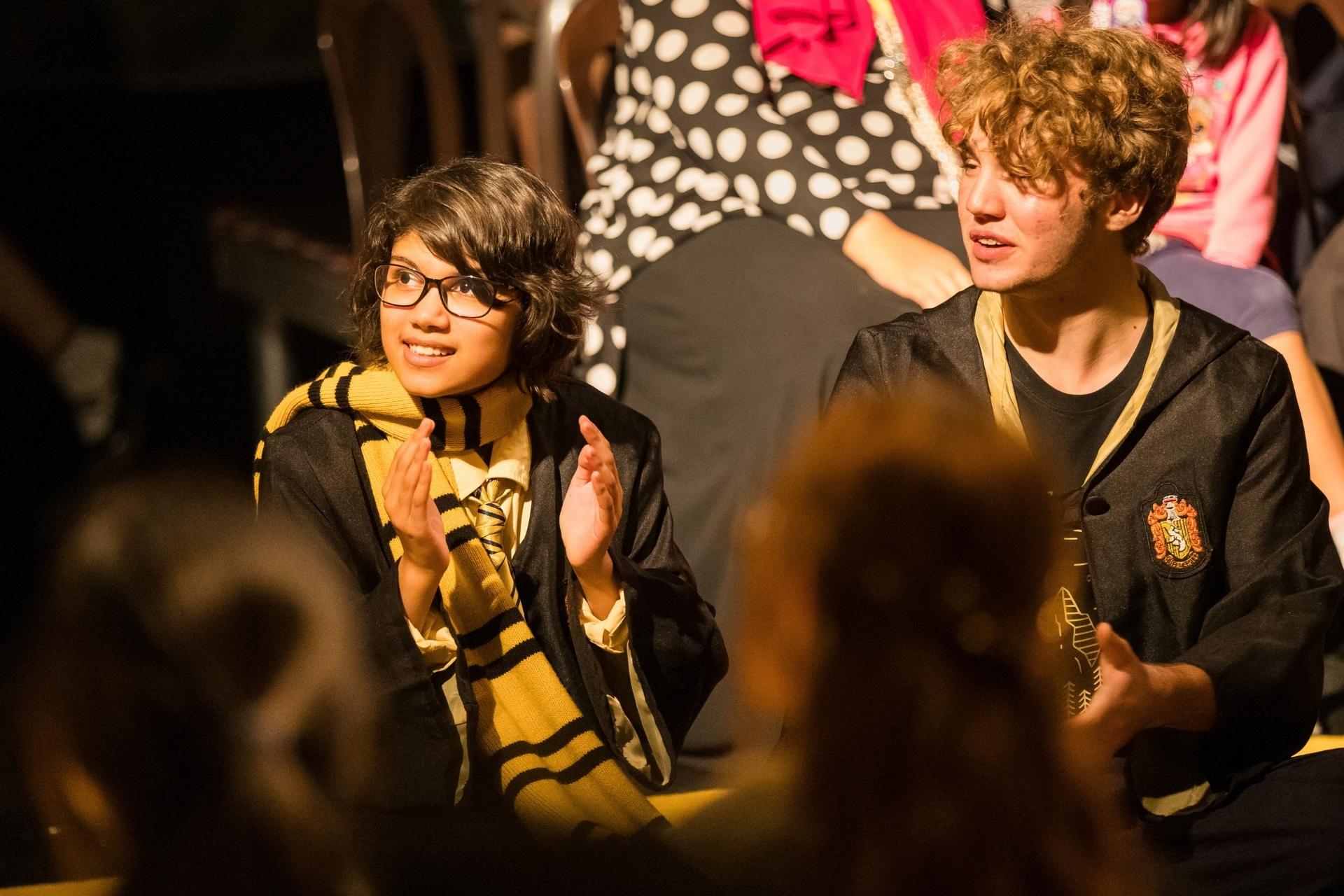 AISM Middle and Senior School students performing on stage in the Puffs school drama production